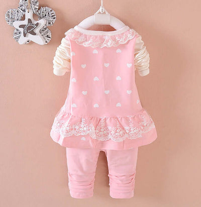 BibiCola Baby Girls - Pink heart-patterned dress with lace details on a beige background