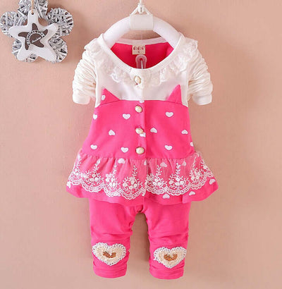 BibiCola Baby Girls - Children's pink outfit with white lace details on a beige background