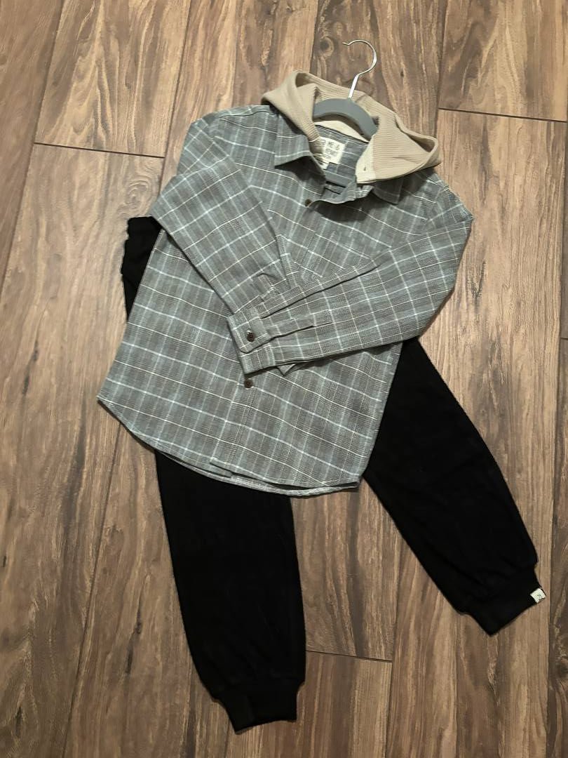 Stack of folded clothing on a wooden floor