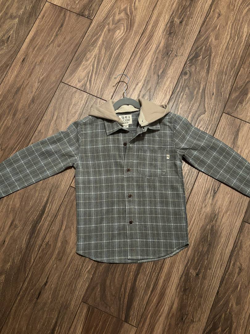 Plaid shirt with a hood on a wooden floor