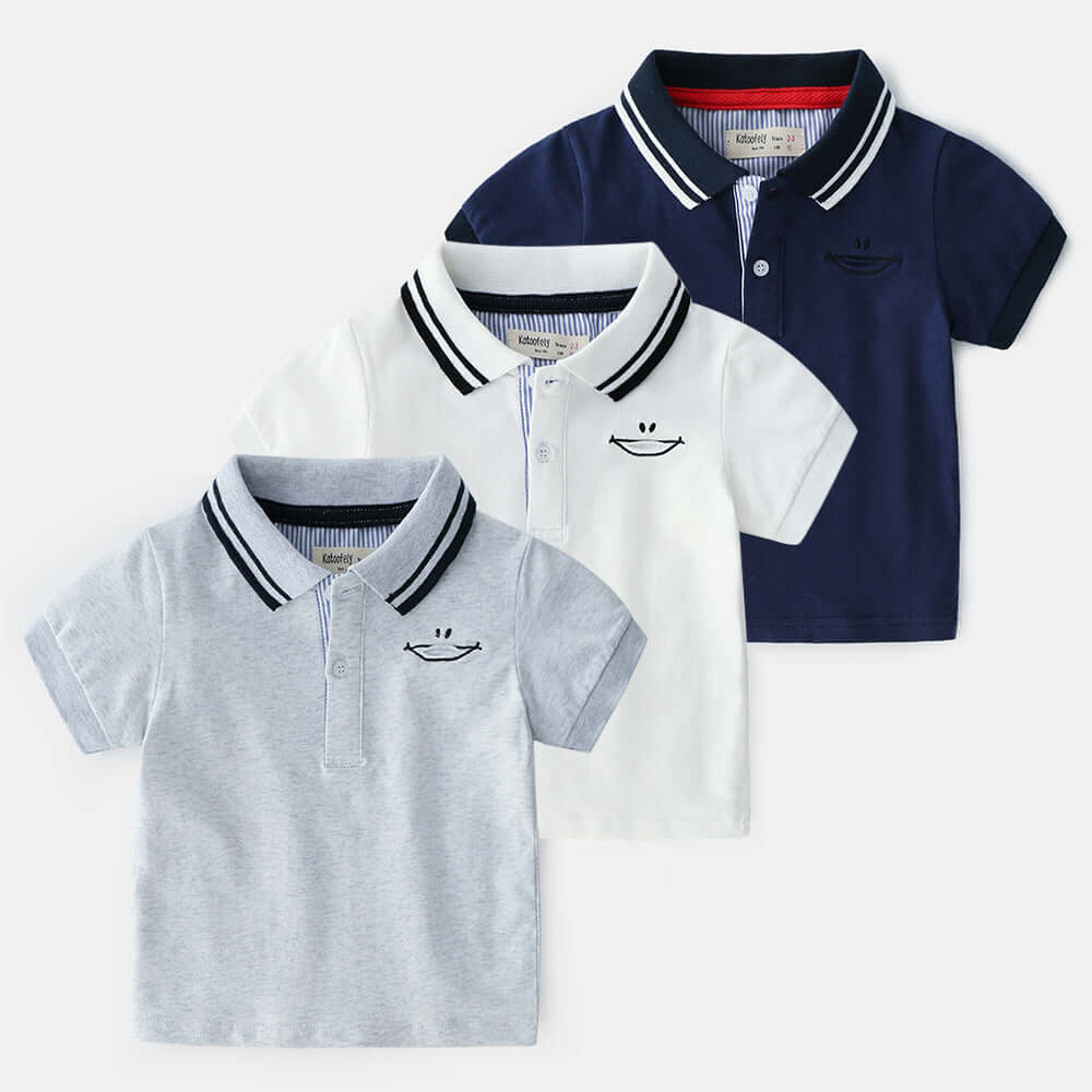Childrens Polo Shirt -Three children's polo shirts in white, gray, and navy on a white background