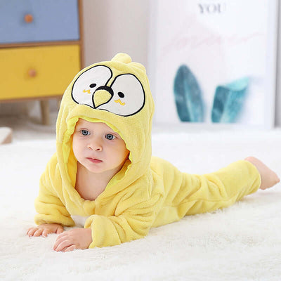 Flannel bodysuit-Baby wearing a yellow cartoon character onesie on a white blanket.