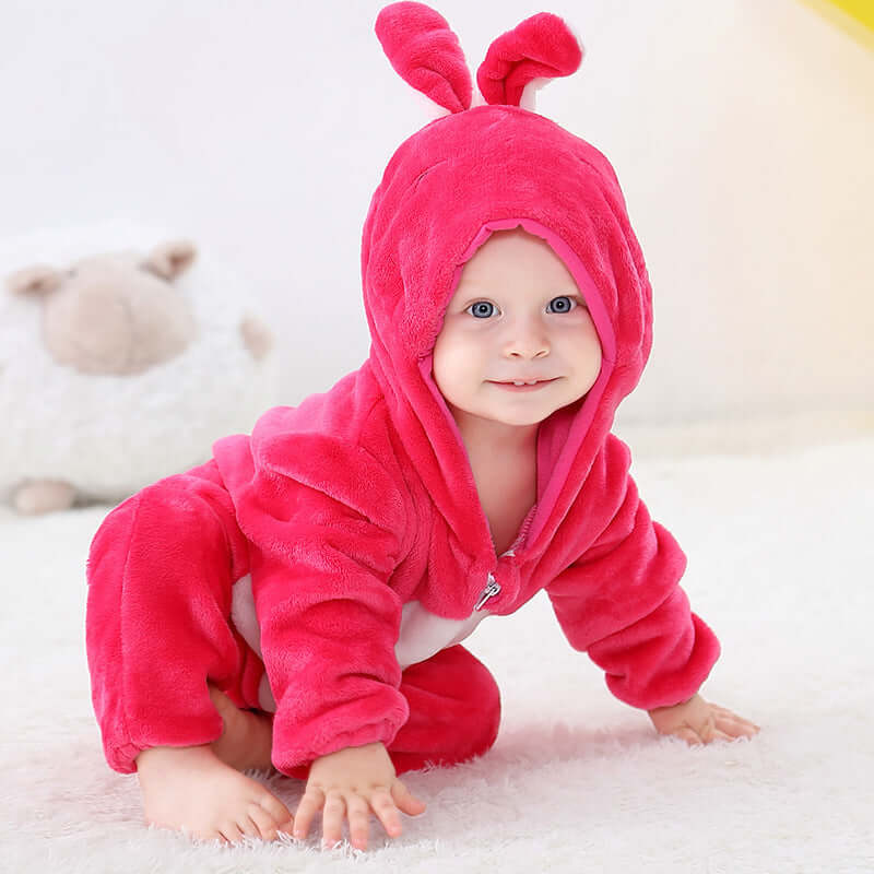 Flannel bodysuit-Baby in a pink caterpillar costume on a soft surface