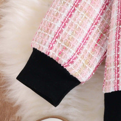 Girls Autumn Kafuu Woolen Top Skirt-Close-up of a pink and white textured fabric with black trim on a fluffy white surface.