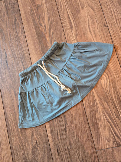 Girls Bamboo Skort-Teal shorts with a drawstring on a wooden floor