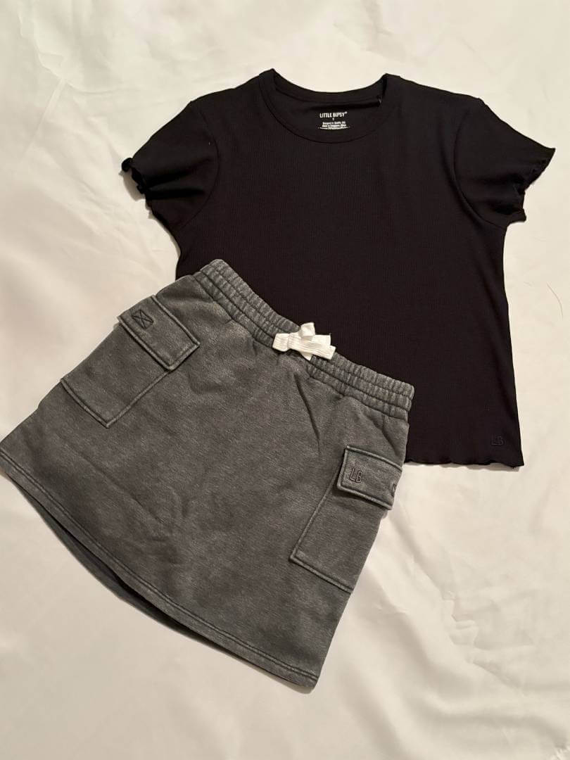 Girls Black Lettuce Trim Tee-Black t-shirt and gray shorts on a light background