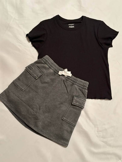Girls Black Lettuce Trim Tee-Black t-shirt and gray shorts on a light background
