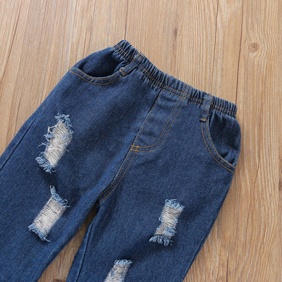 Girls Flared Sleeve Top Denim Trousers-Distressed blue jeans on a wooden surface