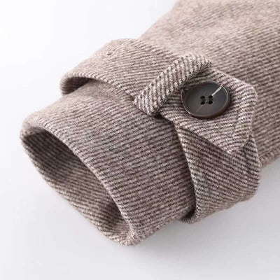 Girls Pleated Short Skirt-Close-up of a textured fabric sleeve with a button on a light background