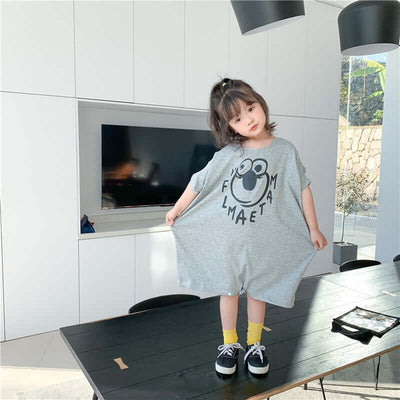 Loose Casual Short Sleeve Top-Child wearing a gray dress with a logo in a modern indoor setting