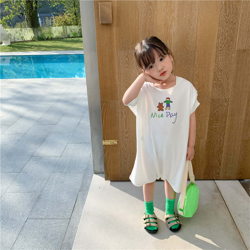 Loose Casual Short Sleeve Top-Child wearing a white dress with a printed design, standing by a poolside.