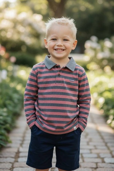 Red & Black Stripe Long Sleeve Midway Polo by Me and Henry-Young boy wearing a striped shirt and shorts standing outdoors with a blurred background