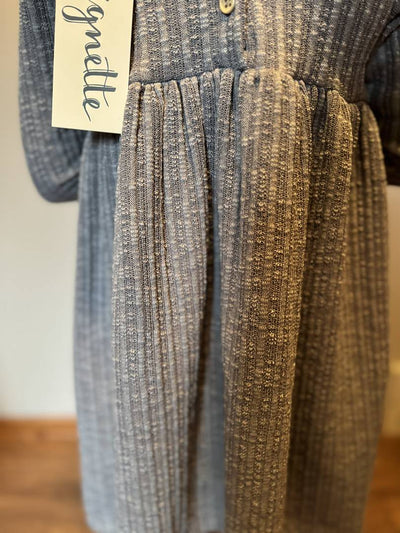 Textured dress with a brand tag on a neutral background