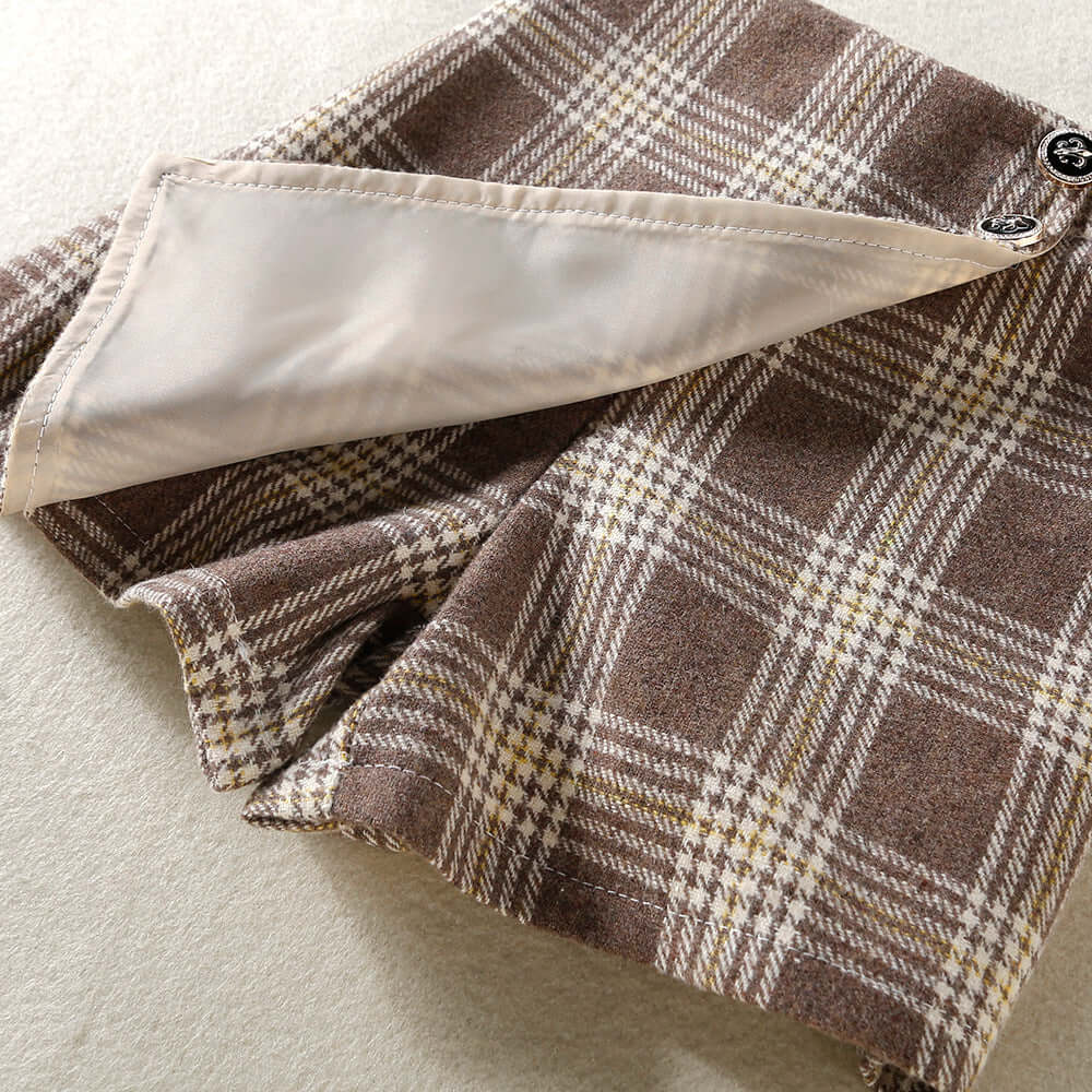 Solid Color Top  Plaid Skirt-Close-up of plaid fabric with a button on a neutral background