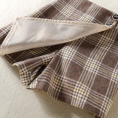 Solid Color Top  Plaid Skirt-Close-up of plaid fabric with a button on a neutral background