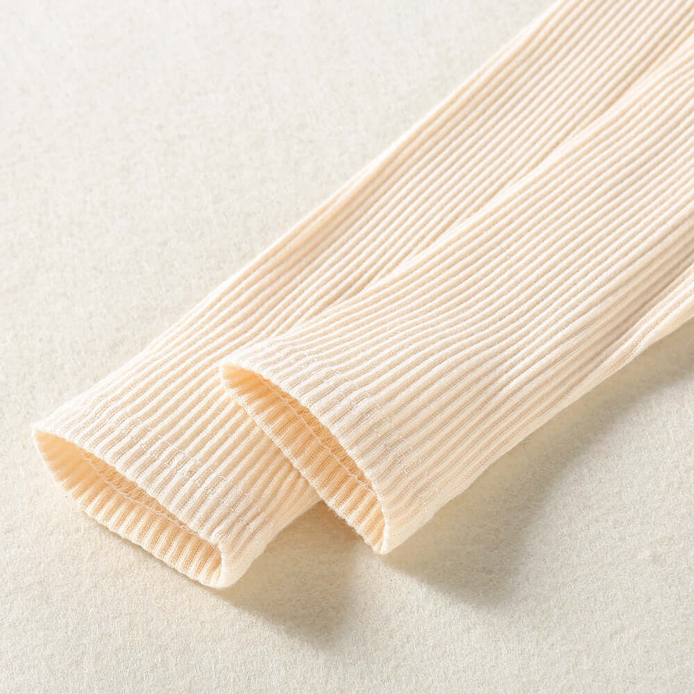 Solid Color Top  Plaid Skirt-Close-up of ribbed beige fabric on a light background