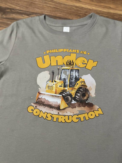 Under Construction Graphic Tee-Gray t-shirt with a bulldozer graphic and 'Under Construction' text on a wooden surface