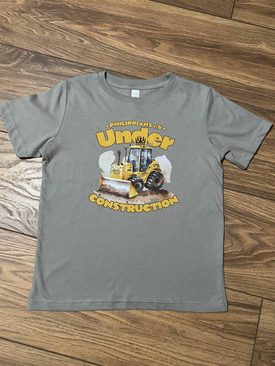 Under Construction Graphic Tee-Gray t-shirt with construction graphic and text on a wooden surface