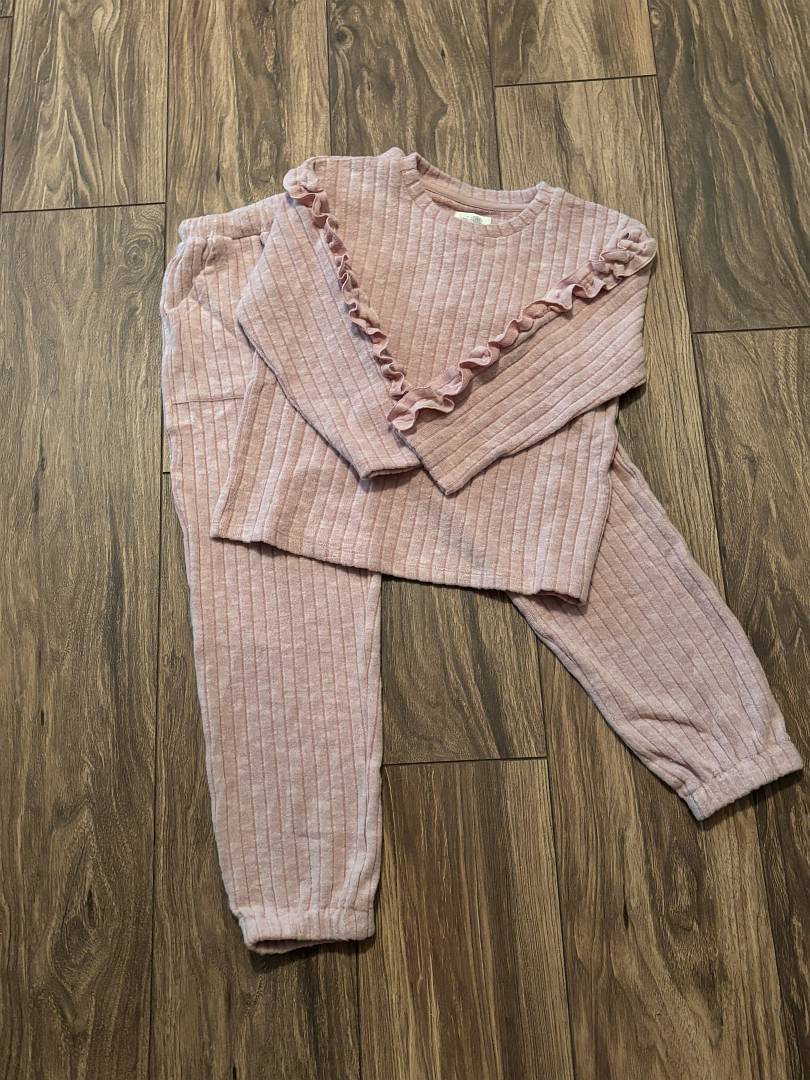 Pink ribbed jogger set on a wooden floor