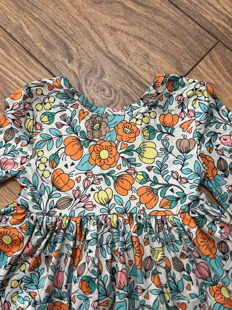 Vintage Vibes 3/4 Pocket Twirl Dress-Colorful floral dress with flowers and leaves on a wooden floor