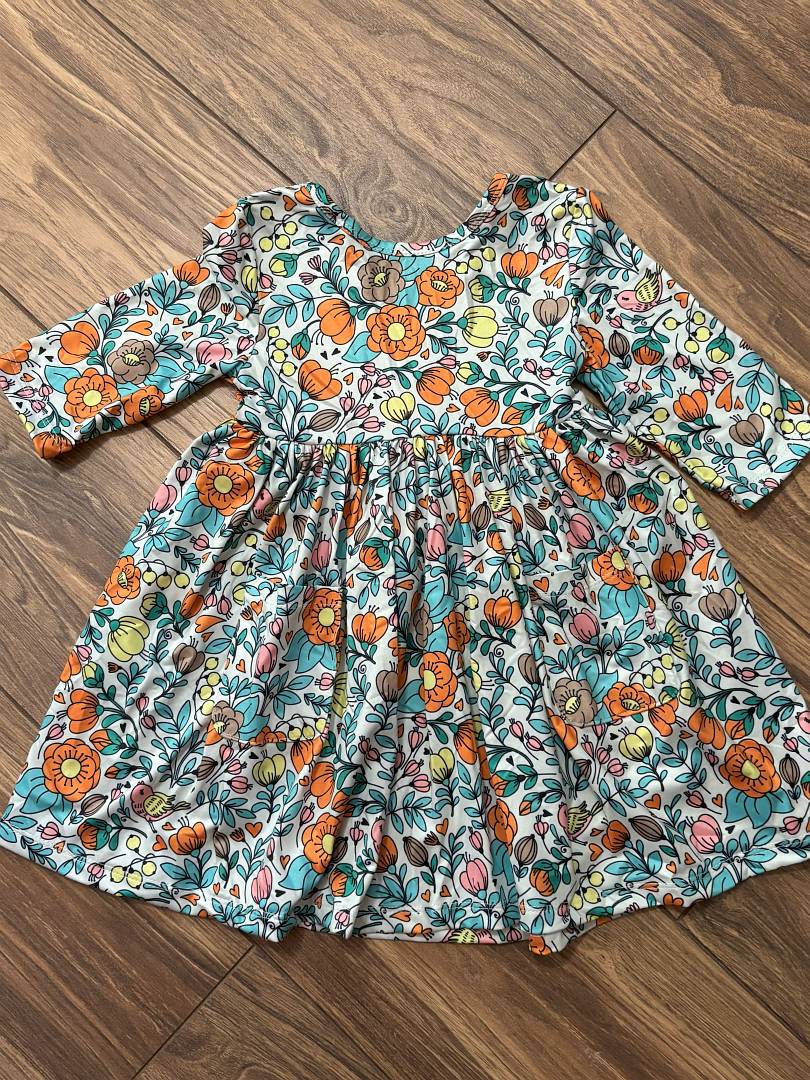 Vintage Vibes 3/4 Pocket Twirl Dress-Floral dress with flowers and leaves on a wooden floor