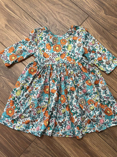 Vintage Vibes 3/4 Pocket Twirl Dress-Floral dress with flowers and leaves on a wooden floor