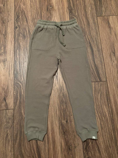 WES Waffle Jogger Pant-Olive Green sweatpants on a wooden floor